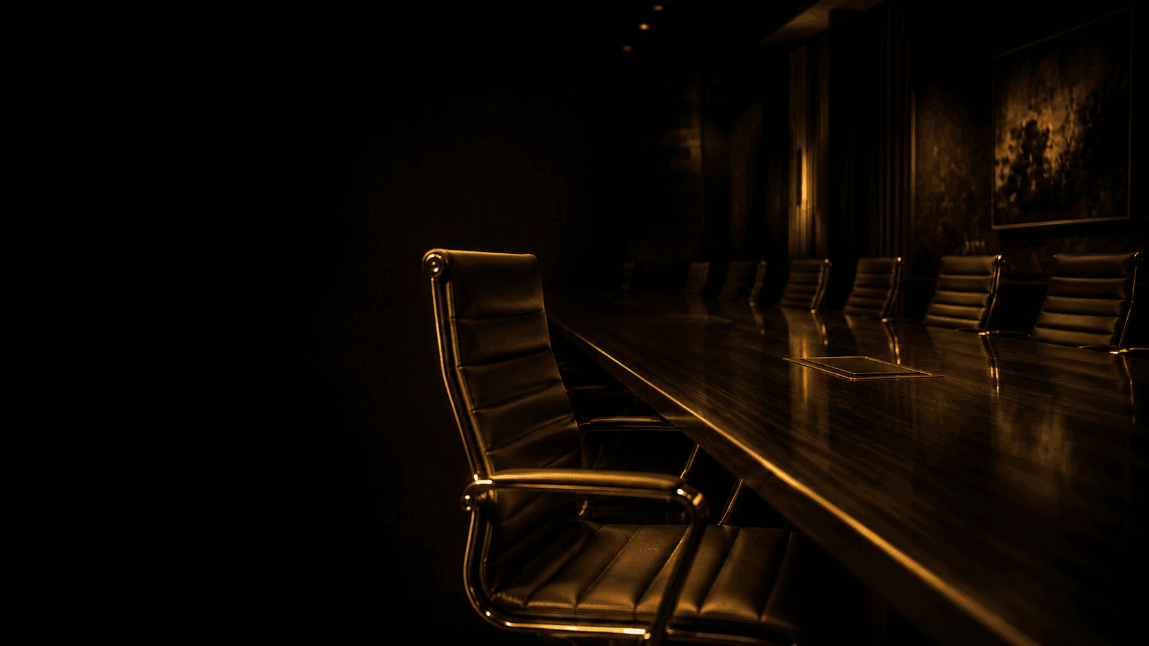 A dark executive boardroom, a long table lined with empty chairs, one chair lit